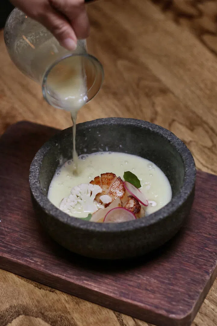 A rich, nutty celery and almond soup served
with seared Hokkaido scallop and cauliflower.

Photo: Courtesy of Open Door Policy