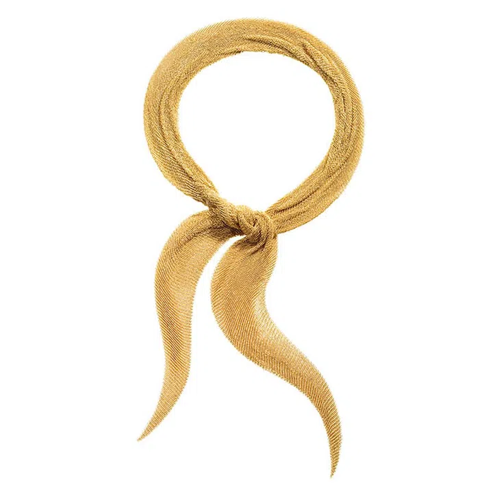 Made completely of gold, the Peretti mesh scarf, created especially for Tiffany, slides on like a necklace and wears like a scarf.