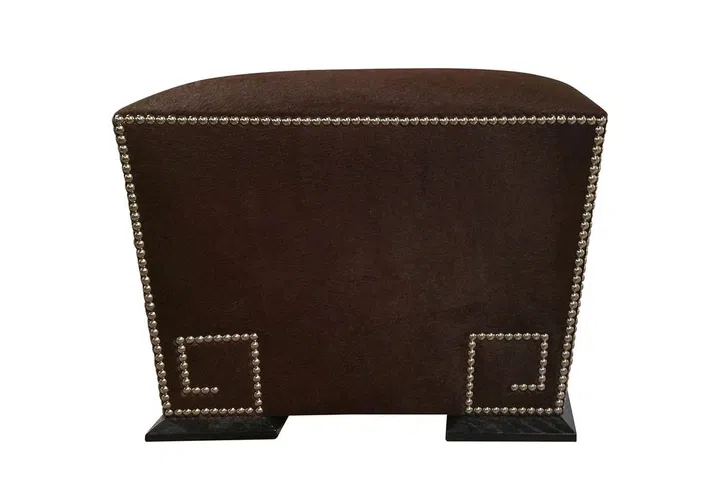 This accent is a classic for upholstered pieces, but it's being used in whole new ways. "We are seeing this trend go beyond the usual upholstery and into storage chests, credenzas, and even base plates of lighting fixtures! Some designers even use nail heads to create a pattern on the piece of furniture," says Jennifer Koen, senior vice president for business development at the luxury consignment site Viyet. The Greek Key ottoman by the Madeline Stuart Collection offers a modern take on the familiar pattern via nailheads.