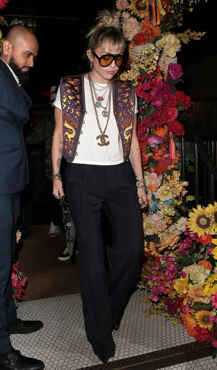 The star wore tailored trousers, an ornate embroidered waistcoat, with an assemblage of Chanel jewels for a dinner date in London.

Photo: Getty
