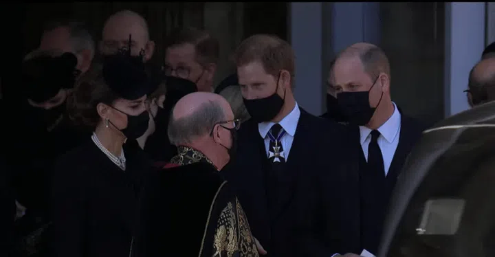 Prince Harry chatting with Prince William and Kate Middleton following today’s funeral service. (Photo: BBC YouTube)