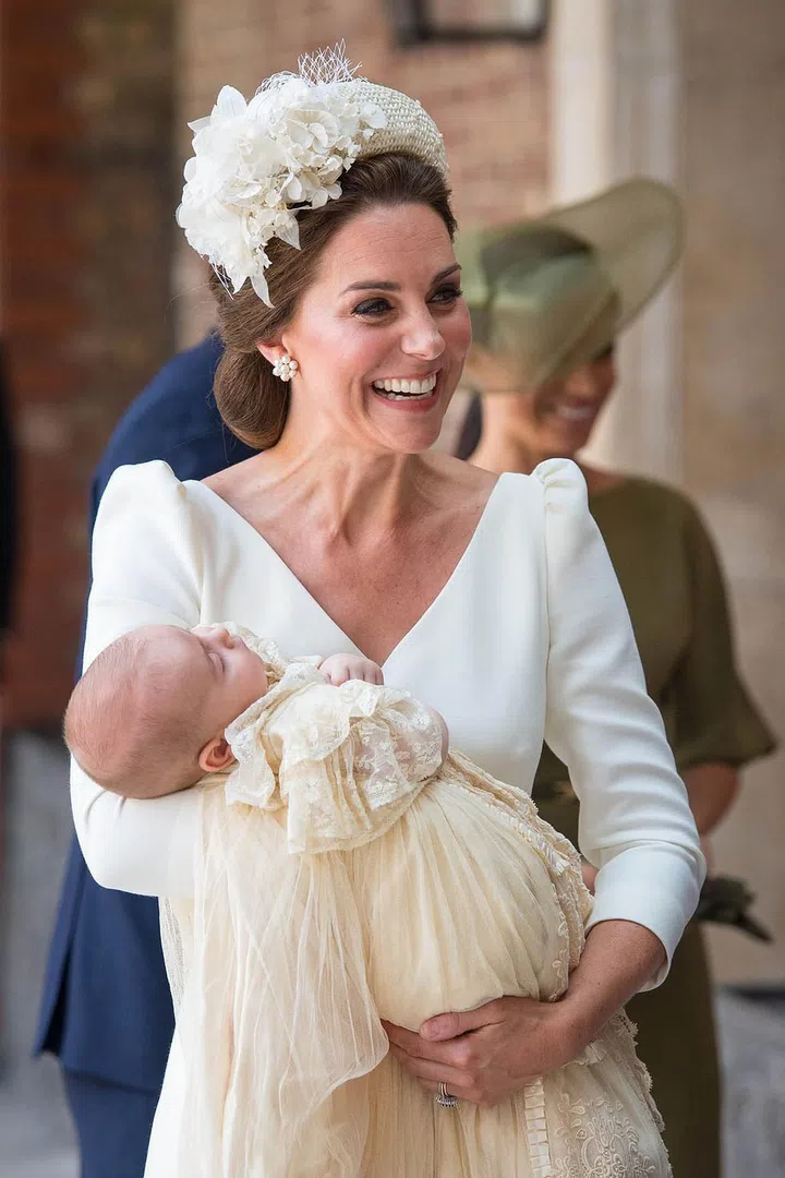 She was all smiles as she entered the Chapel Royal at St. James' Palace in London. Prince Louis wore the traditional christening dress passed down through the British royal family. Photo: Getty