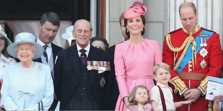 Queen Elizabeth II, Prince Philip, the Duchess of Cambridge, Princess Charlotte, Prince George, and Prince William look out from the balcony of Buckingham Palace during the Trooping the Colour parade in London.