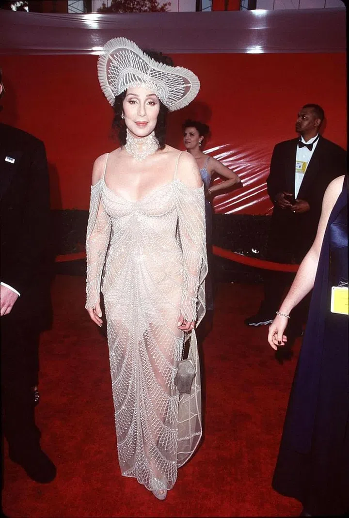 Going for another headpiece look, Cher shut down the '98 Oscars in a nude see-through dress and matching choker. Photo: Getty