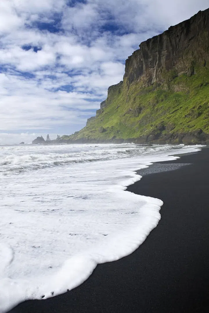 Iceland might not conjure up images of a beach vacation, but the black sand beaches of its southernmost town, Vik, are worth exploring.