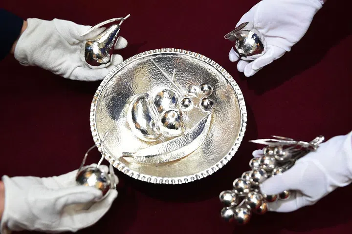 This planished silver bowl was gifted to The Queen in 1991 by then president of Zambia, Kenneth Kaunda. It contains silver models of the many fruits grown in the country. Photo: Getty