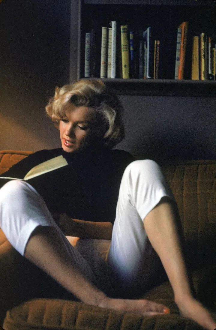 In a turtleneck and slim-fit pants.