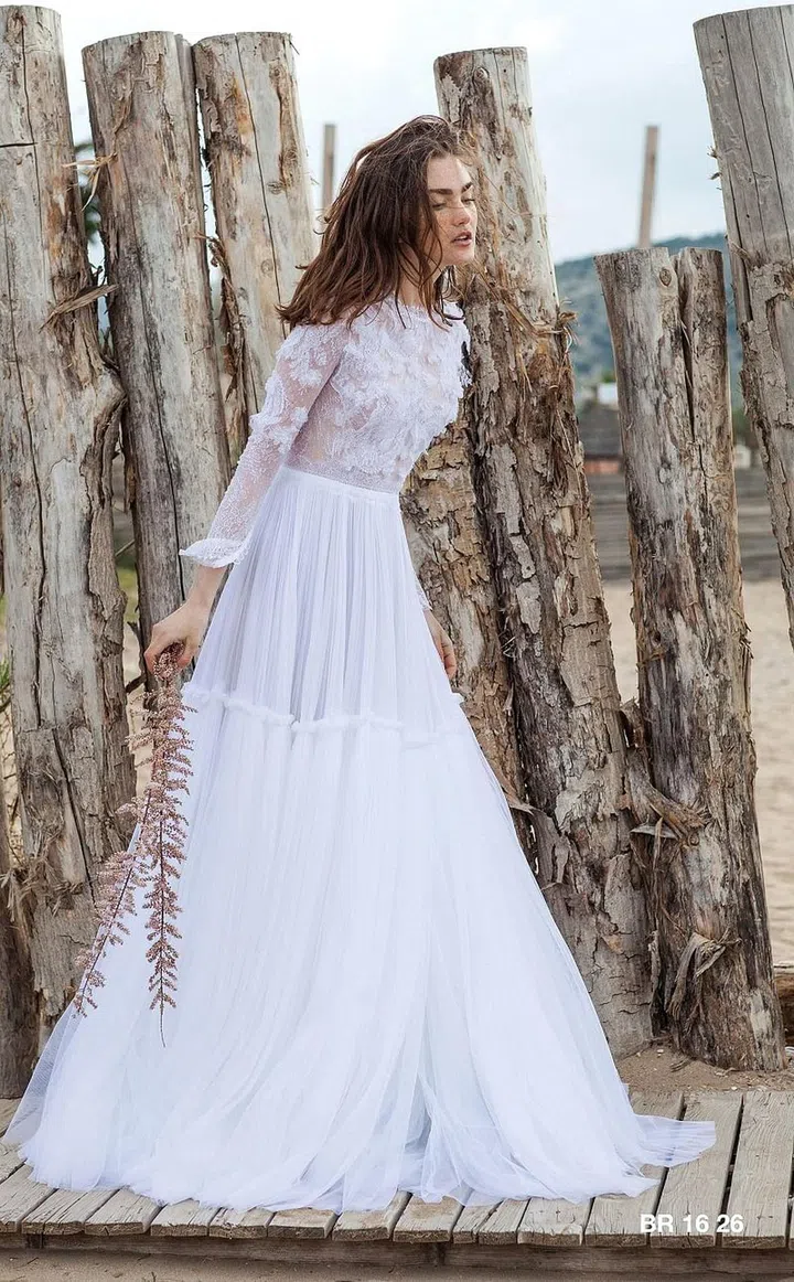 Greek native Christos Costarellos merges the ease of the Mediterranean with the construction, attention to detail and fabric quality of a Parisian house. Often utilizing multiple laces to create one single silhouette, this designer is never looking for the easy way out when it comes to designing for his beloved polished bohemian. Imagine discovering new details in each fitting and up until your wedding day–from hand cut fluttery appliqués used to create that much more texture and dimension to a softly frayed hem intended to make the wearer appear effortless to a soft puckering atop a single tier in your skirt. This is the brand for those who are torn between going barefoot on the beach or airing on the side of something more refined.