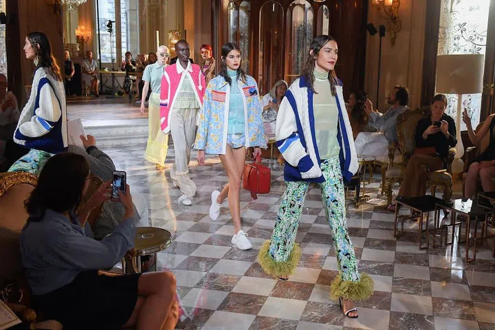 Models walk Miu Miu's runway, including Alexa Chung and Kaia Gerber.