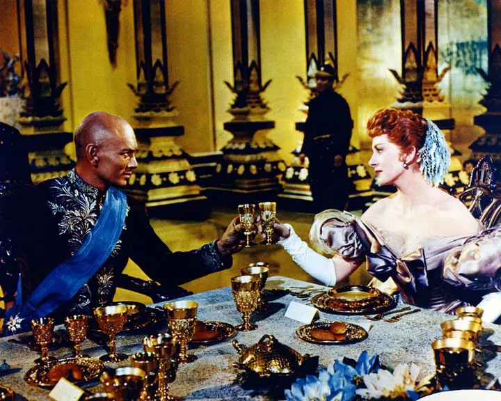 Yul Brynner reprised his Broadway role as the King of Siam in the movie remake of The King and I, a movie for music, fashion, and design lovers that's full of sumptuous fabrics and ballroom dance scenes. The musical follows the budding romance between the King and his children's governess, Anna, which earned Brynner an Academy Award. Photo: Getty




















