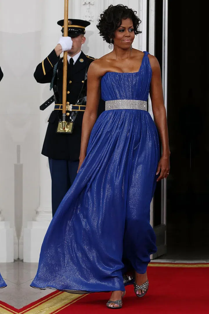 The First Lady sparkles in an electric blue dress by Peter Soronen.