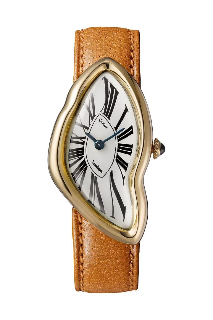 Cartier London, 1967 — Gold, one sapphire cabochon and leather strap - Tradition holds that this model represents an interpretation of a watch damaged in a crash. Cartier Collection. Photo: Cartier