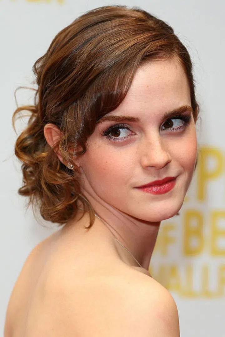 Curls pinned and tucked behind one ear channels Old Hollywood vibes.