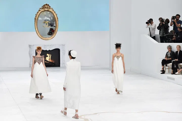 We can't quite help but hum the "Breakfast at Tiffany's" theme song when we see this overtly classic set from Paris Fashion Week. A vintage gilded mirror is the staple of sophistication a brand like Chanel demands, complemented by Tiffany blue and a cozy, elegant fireplace. You can take this vignette directly to your living room.