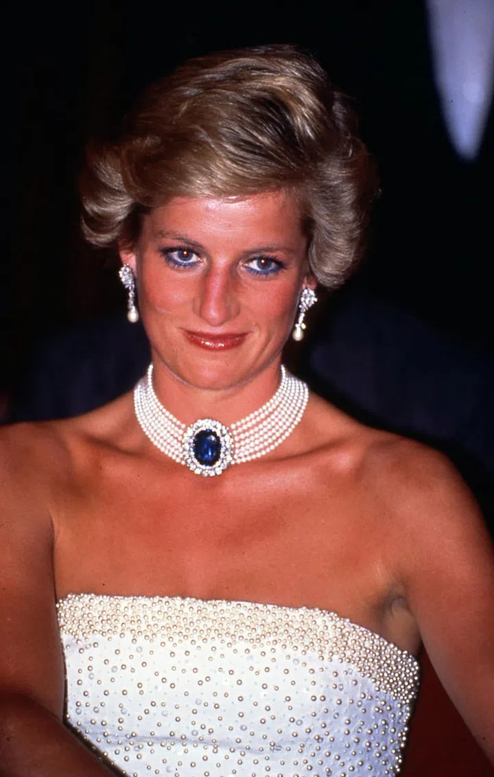 BUDAPEST , HUNGARY - MAY 07:  Princess Diana, Princess of Wales wearing a white strapless dress, embroidered with pearls, designed by Catherine Walker and a pearl and sapphire choker, as she attends a banquet on May 07, 1990 in Budapest, Hungary (Photo by Anwar Hussein/Getty Images)