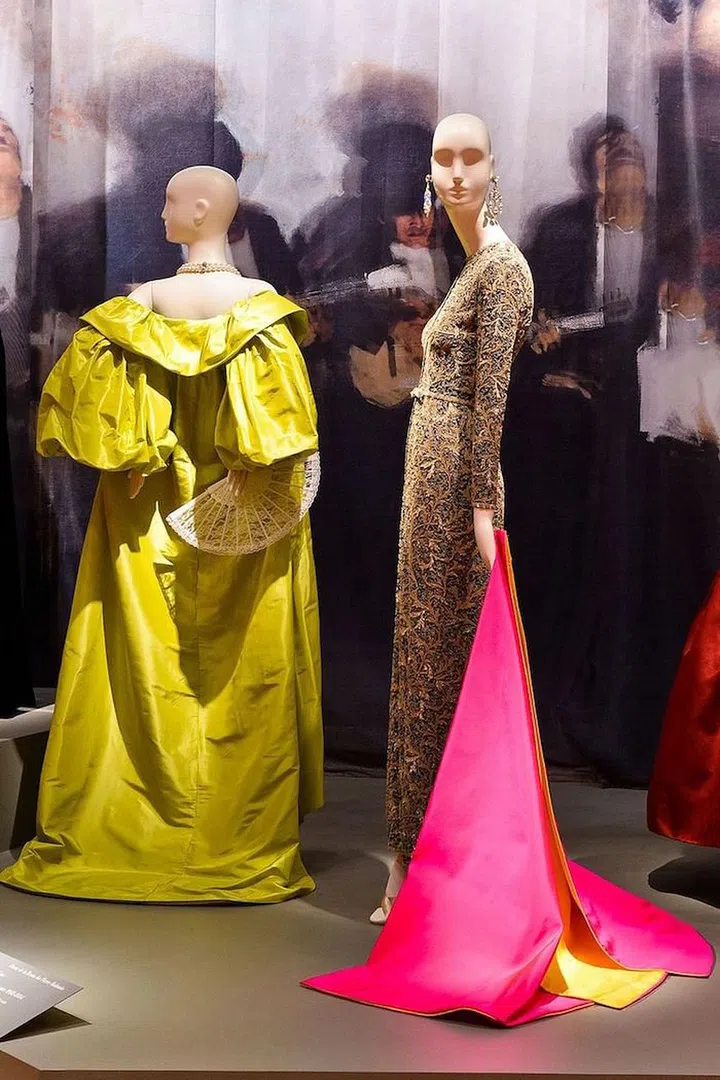 Left: Oscar de la Renta, Custom Evening Coat, 2012, silk taffeta, the Collection of Annette de la Renta (worn by Annette de la Renta at the Schiaparelli and Prada: Impossible Conversations Costume Institute Gala at the Metropolitan Museum of Art, 2012).
<br>
Right: Oscar de la Renta, Evening Dress, fall 1996, silk crepe with bead and sequin embroidery, the Collection of Annette de la Renta; Evening Cape, fall/winter 1993–94, silk satin, the Collection of Annette de la Renta
