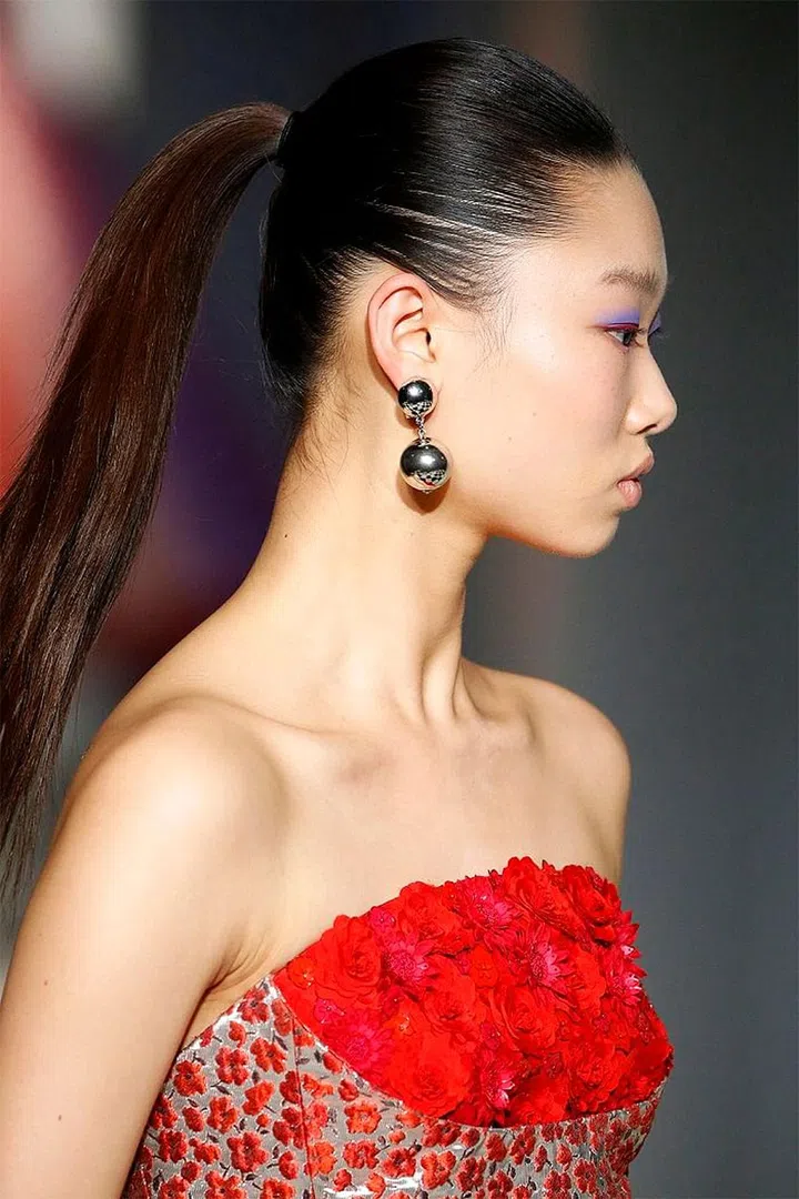 When hairstylist Orlando Pita caught a glimpse of the new Oscar De La Renta collection, he was most inspired by its youthful energy. "It's really Oscar for a younger girl," he says. "I thought, you know,what would be the one hairdo a young girl could wear that she's still a bit rebellious when her mother buys her an expensive piece of clothing like this? It's a ponytail. The mother would freak out like, 'You can't wear a ponytail with that!' So if the mother doesn't like it—it's good," says Pita.
