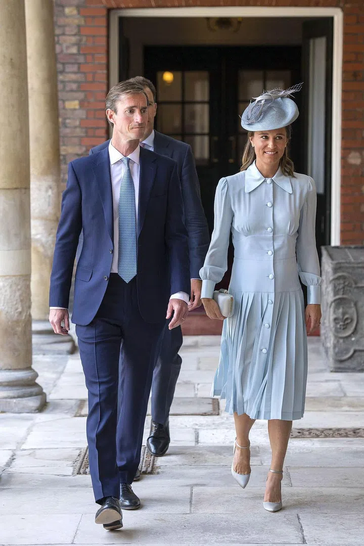 Pippa Middleton, who wore a pale blue Alessandra Rich dress, arrives with husband James Matthews. Pippa, Kate's younger sister, is expecting her first child this fall. Photo: Getty