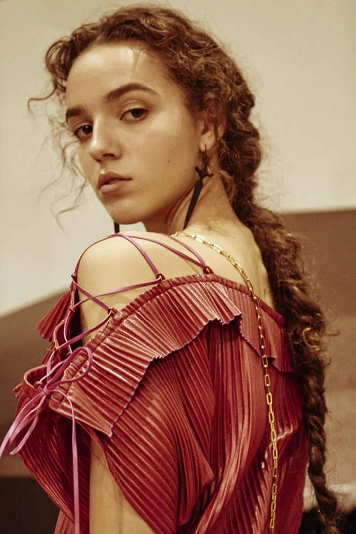 The Look: Romantic Braid
How-To: It was designer Pierpaolo Piccioli's first Valentino runway show as a solo designer, but that doesn't mean he was going to shake things up all too much. If it works, it works. That also translated into the beauty look, where hairstylist Guido Palau created a single long, fuzzy braid that was unmistakably Valentino. After the hair was curled, a one-inch section was pulled back and crossed over on each side, then secured with a bobby pin. Palau blasted the hair with Redken Wind Blown 05 to set the airy texture, braided it loosely, and then secured it with a single black hair tie. The beauty look wasn't shocking or on-trend: but it was soft, pretty, and iconic Valentino.