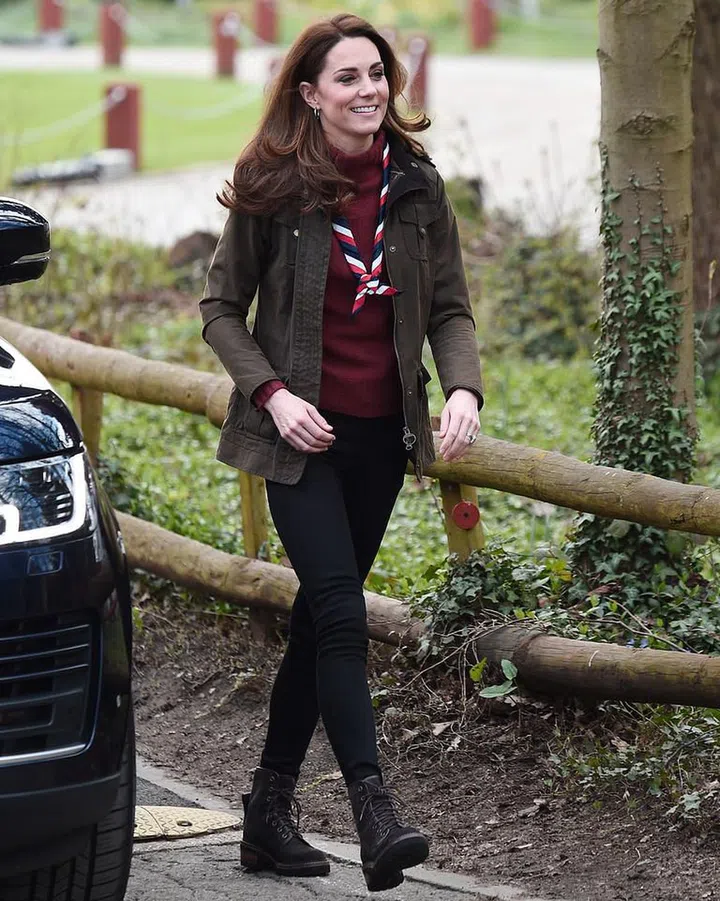 Yesterday Kate visited the Scouts Headquarters in London's Gilwell Park, where she learned about exciting piloting initiatives for young children ages four to six years old. For the event she wore her beloved and very warm-looking J. Crew mock-neck sweater in burgundy and her cool Chloe combat boots to add a tough, cool-girl vibe to her look. She finished the look with black skinny jeans (her go-to) and an olive jacket.