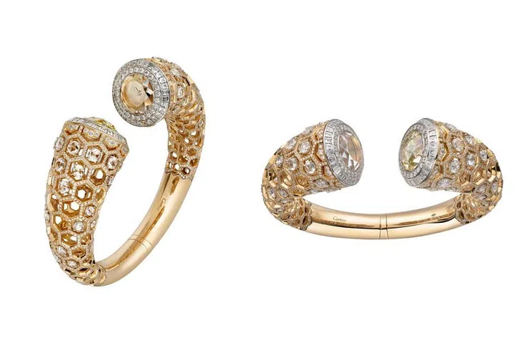 Honeycomb hideout! A combination of yellow and white gold conceals a timepiece within a dazzling hexagon patterned bangle. The bracelet contains a round-shaped rose-cut diamond of 7.31 karats, 1,721 brilliant-cut diamonds totaling 6.42 carats, 61 rose-cut diamonds totaling 13.92 carats, and 60 princess-cut diamonds totaling 3.62 carats.
Price Upon Request. cartier.com