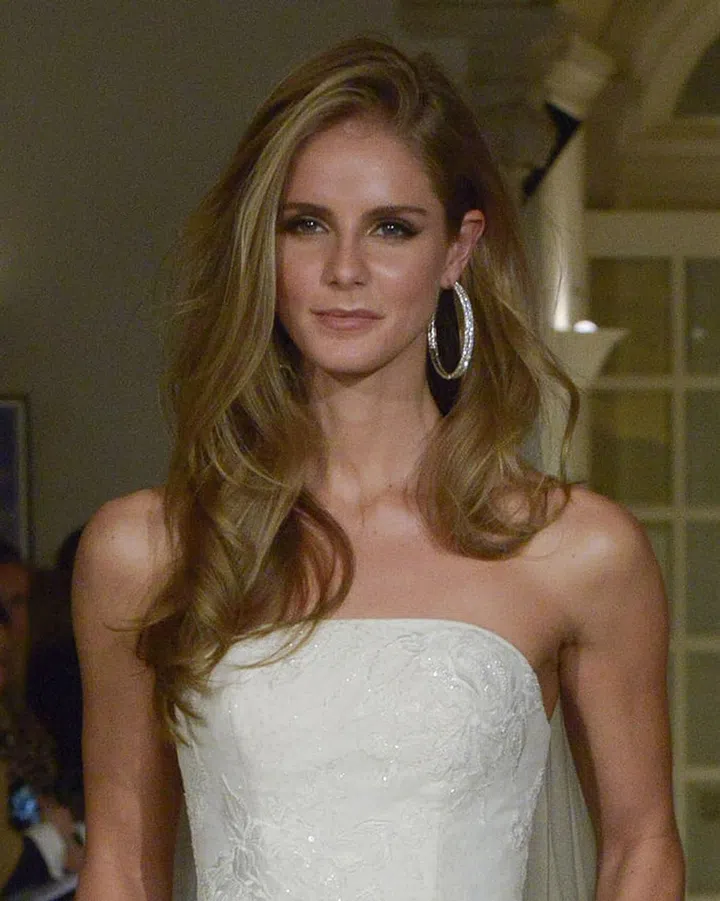 The voluminous '80s-inspired hair flip seen on the ready-to-wear runways also made it to bridal at the Oleg Cassini show. With a glittery hoop, it's for the bride who wants to look casual but not beachy or undone.