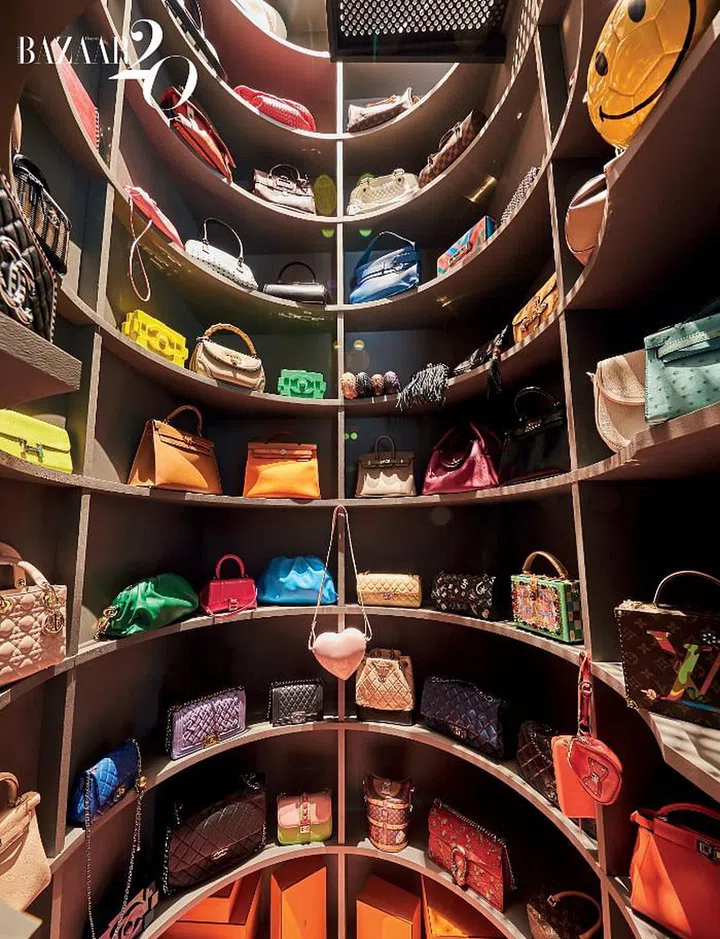 Chuah’s collection of handbags rests on neutral brown arc-shaped shelves in her Bag Baptistry room.

Photo: Phyllicia Wang