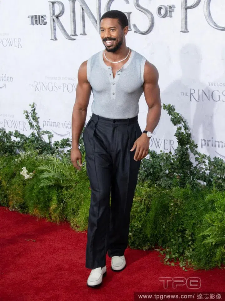 Michael B. Jordan flashes his guns in a sleeveless knit. 