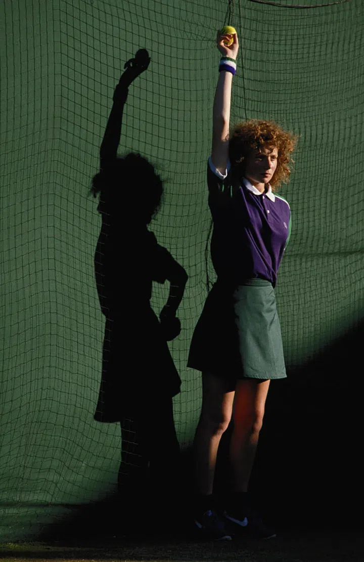 A ballgirl waits with her arm up to deliver a ball. Photo: Getty