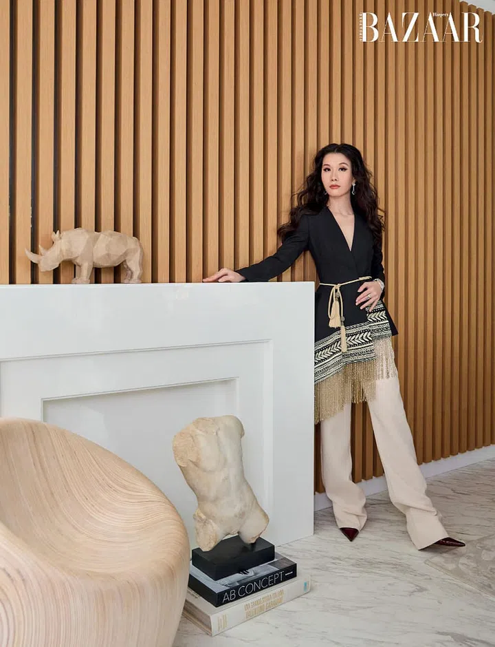 She pairs her own Oscar de la Renta blazer, Gucci trousers and Bottega Veneta pumps, with matching Van Cleef & Arpels earrings and necklace (worn as bracelet)