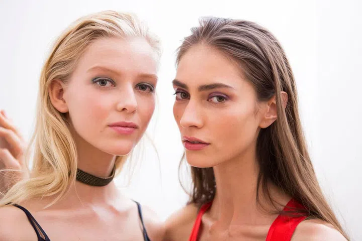 The Look: Glossy Eyes
How-To: The vibrant colours of Nina Ricci's Rio-inspired spring 2017 collection could also be found on the eyes of the models, where Diane Kendal has created multiple shades of glossy lids. Using grease paints in purple, orange, and blue, Kendal swept them on with a brush and then added a dab of Elizabeth Arden Eight Hour Cream on top. The pigments mixed and swirled with the slick balm, resulting in shades that looked slightly different—but equally as captivating—on each model.