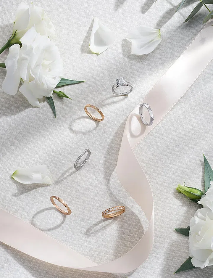 Clockwise from top: GRAFF Laurence Graff Signature Collection ring with a 2.02-carat round diamond; white gold wedding band; pavé diamond rose gold wedding band, from $2,300; Spiral Collection rose gold wedding band; pavé diamond white gold wedding band, from $3,000; Laurence Graff Signature Collection rose gold wedding band GRAFF.com