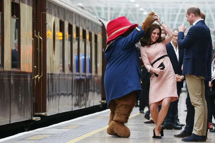 Kate Middleton dances with Paddington Bear at Paddington Station as she meets the cast and crew from the forthcoming film Paddington 2.