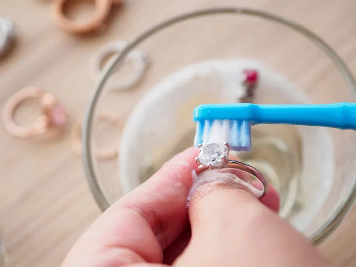 cleaning diamond ring with toothbrush soapy water | Harper’s BAZAAR’s Ultimate Jewellery Cleaning And Storage Guide