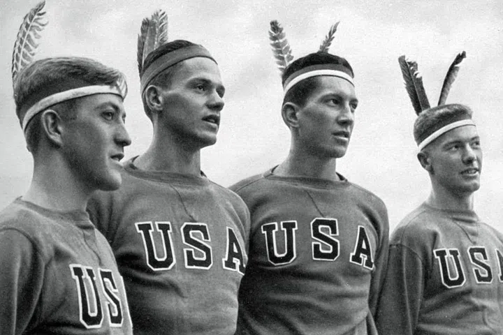 The American gold-medal-winning rowing team wearing headdresses in Berlin. Photo: Getty