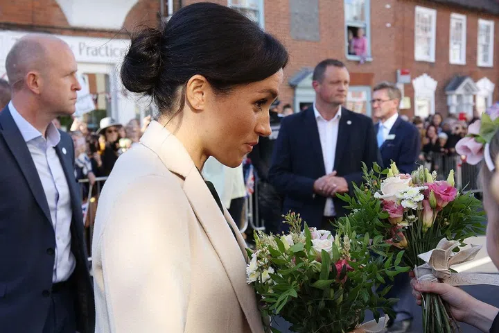 The duchess wore her hair centre-parted and pulled back into a low bun.