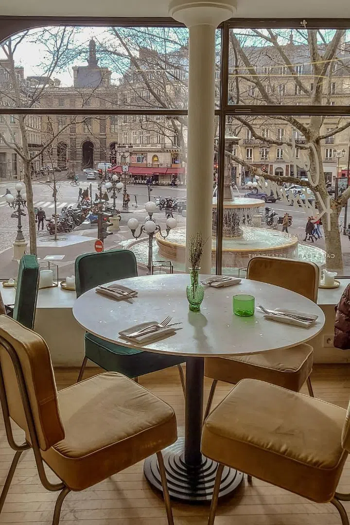 The modern interior of Café Kitsune juxtaposes the historic facades of La Comédie-Français Theater.