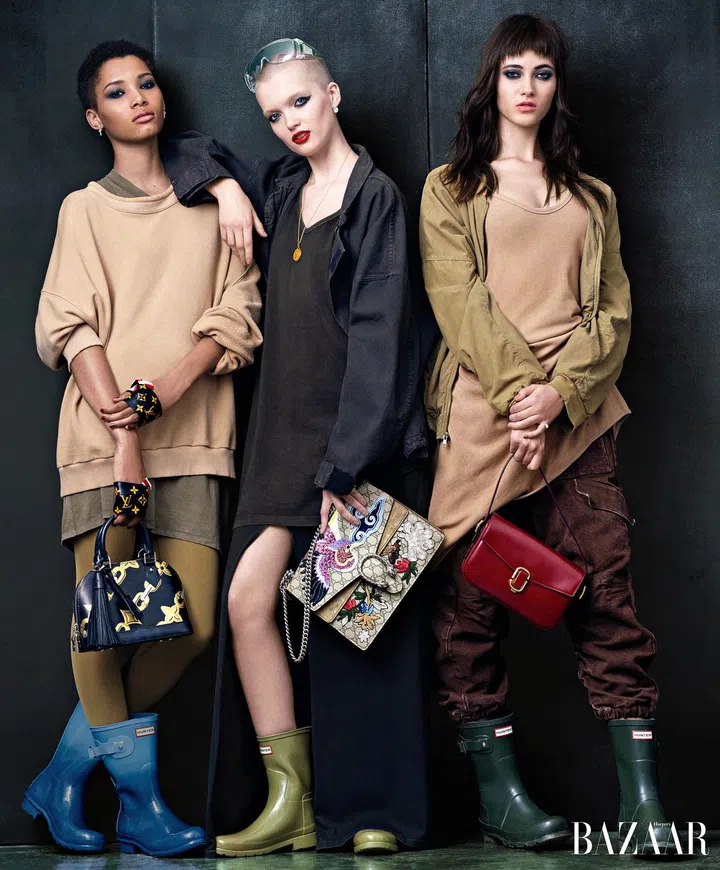 On Lineisy: Yeezy Season 2 sweatshirt, shirt, and leggings; Louis Vuitton bag; On Ruth: Yeezy Season 2 jacket, top, and skirt; Gucci bag; On Greta: Yeezy Season 2 jacket, shirt; Marc Jacobs bag; Hunter boots.