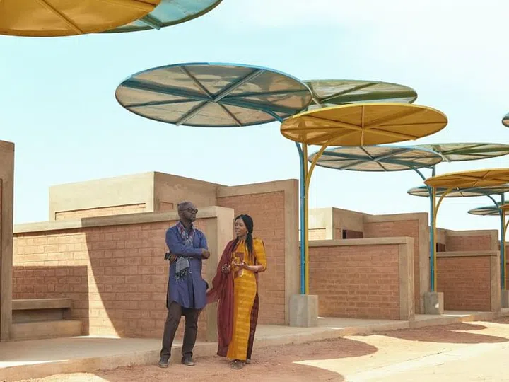 Sir David Adjaye visits the regional market in Dandaji, Niger, with his protégée Mariam Kamara whose practice designed the project. Photo: Courtesy