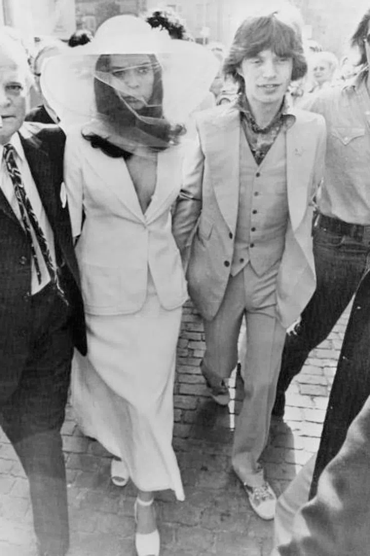 When model Bianca Jagger married Rolling Stones lead singer Mick Jagger in 1971, she wore a low-cut white skirt suit that was by no means traditional, yet it's still easily one of the most stylish celebrity bridal looks of the decade.