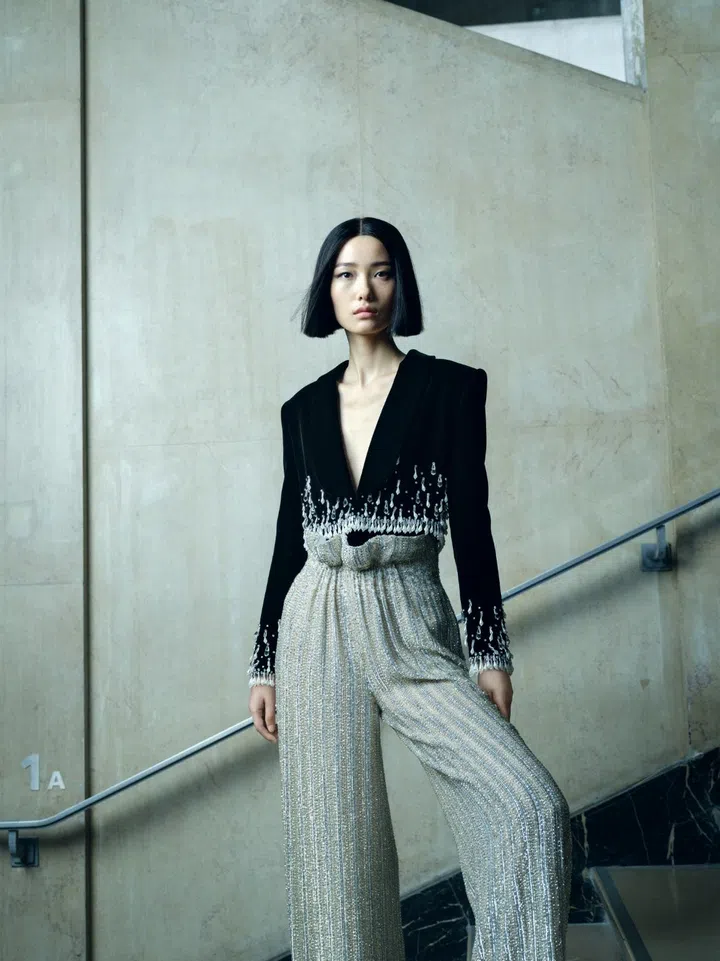 Model wears Armani Privè beaded velvet and silk jumpsuit.