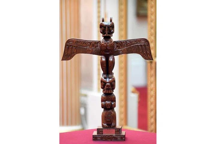 Carved by the Kwakiutl people of Canada, this totem pole was presented to The Queen during a visit in 1971. At the top, it features the mythical thunderbird, believed to bring thunder by flapping its wings. Photo: Getty