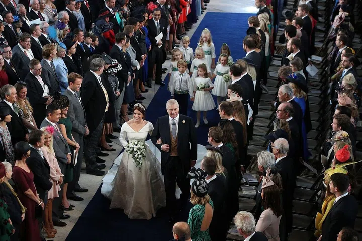 The father of the bride was all smiles as he linked arms with his daughter.