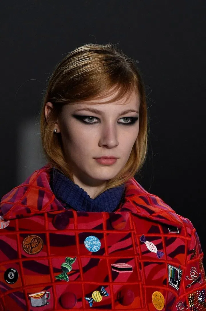 A smudgy and glossy cat eye is the look of choice at the Libertine show. Skin is kept relatively matte and perfected with light contouring and no colour. Lips are a creamy nude in order to play a supporting role to the dramatic eyeliner. Photo: Getty 