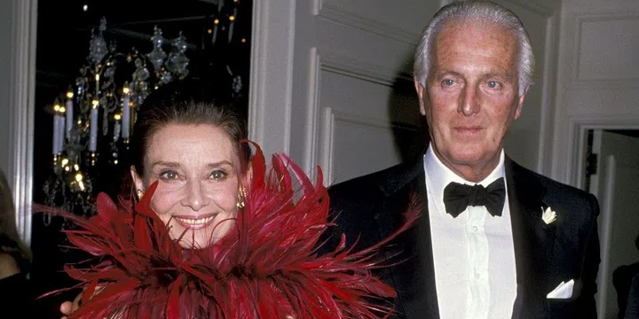 Hubert de Givenchy receives California's Lifetime Achievement Award. For the occasion, Hepburn wore a stunning red feathered look created by the couturier.