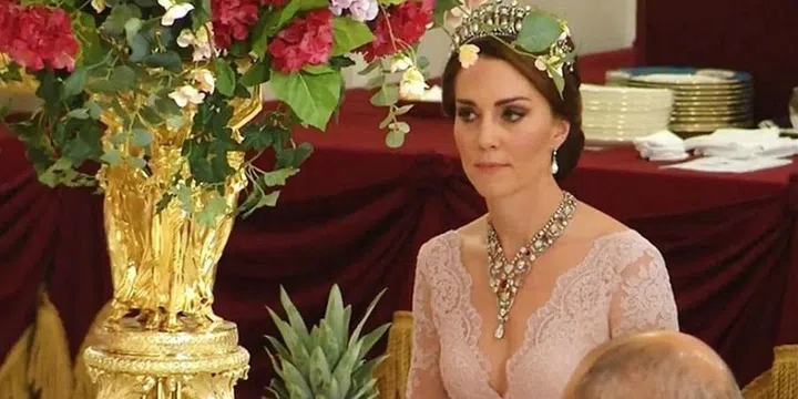 Kate Middleton wearing her late mother-in-law's favorite crown, the Cambridge Lover's Knot Tiara, at a state dinner at Buckingham Palace.