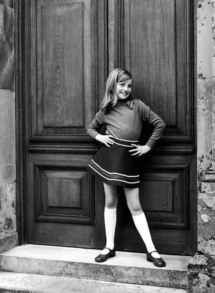 A photo from a private family album shows Diana posing cheekily as a young girl. Obviously a natural in front of the camera, she also had a keen sense of style from an early age.

