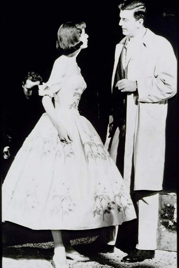 Hepburn trying on one of Givenchy's designs in an undated photo.