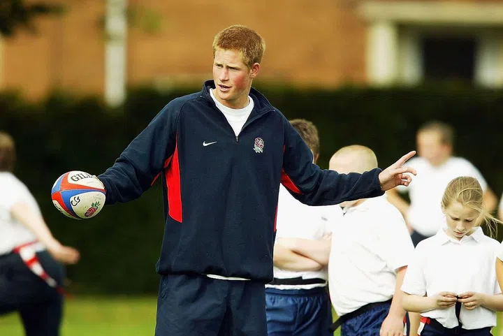 Prince Harry, 20, teaches rugby to school children in Walsall, England.