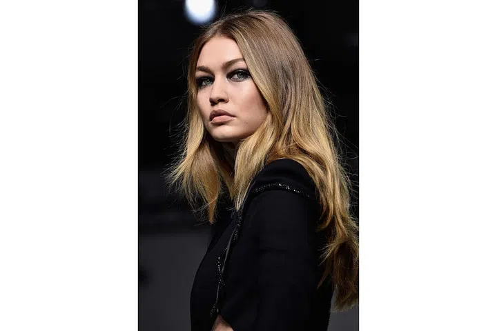 At Versace, dark smoky eyes were set against radiant skin and undone hair. Donatella Versace wanted to emphase each model's individuality, so it was about enhancing natural beauty rather than a uniformed look ; Photo: Getty